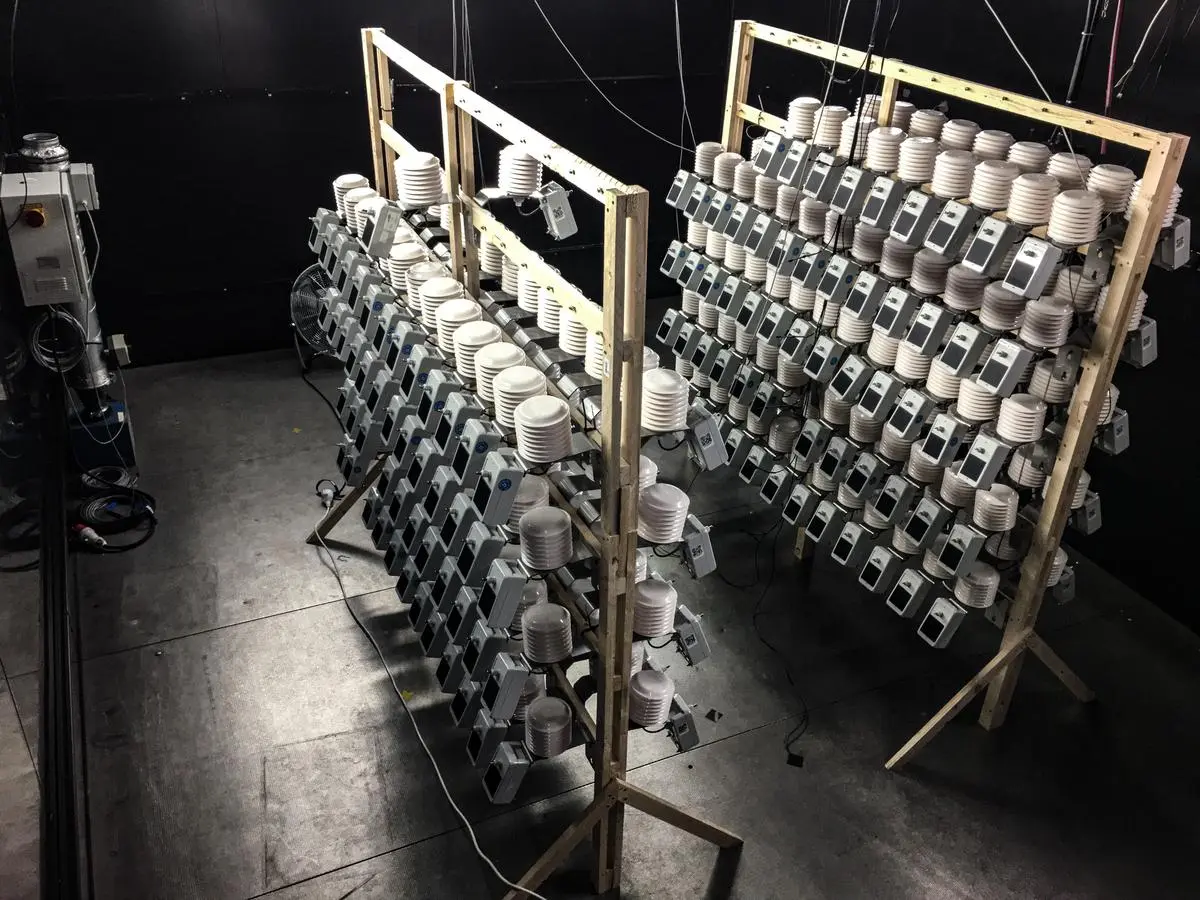 Dozens of climate sensors stand on scaffolding in a test chamber.